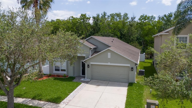 view of front of house featuring a front yard, an attached garage, cooling unit, concrete driveway, and stucco siding