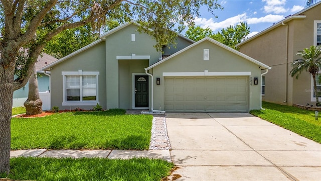 view of front of property featuring a garage, concrete driveway, stucco siding, and a front lawn