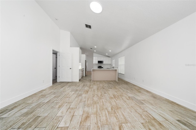 unfurnished living room featuring visible vents, baseboards, light wood-style floors, recessed lighting, and lofted ceiling