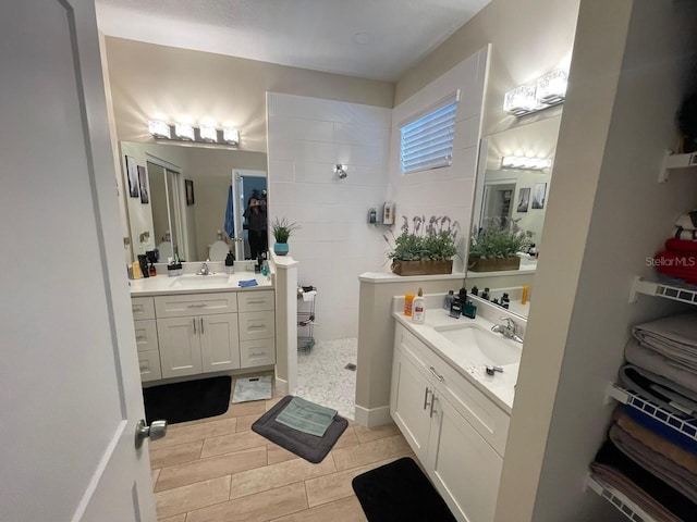 731 Triumph Dr, Sebring, FL 33872 - full bath featuring walk in shower, two vanities, and wood tiled floors