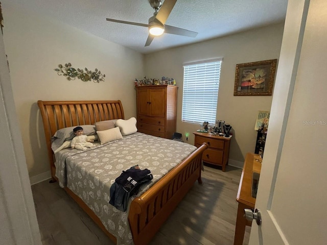 731 Triumph Dr, Sebring, FL 33872 - bedroom with light wood-type flooring, baseboards, a ceiling fan, and a textured ceiling