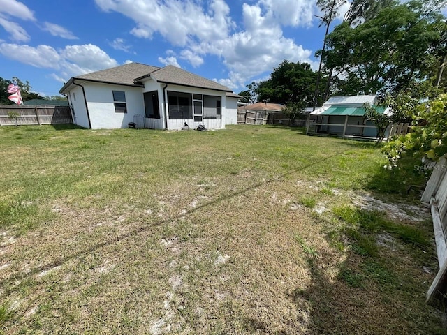 731 Triumph Dr, Sebring, FL 33872 - rear view of property featuring a sunroom, stucco siding, and roof with shingles