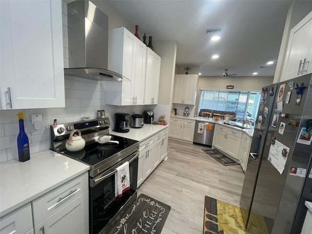 731 Triumph Dr, Sebring, FL 33872 - kitchen with wall chimney exhaust hood, appliances with stainless steel finishes, ceiling fan, decorative backsplash, and recessed lighting