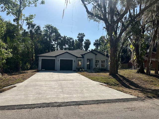 ranch-style home featuring concrete driveway and a garage