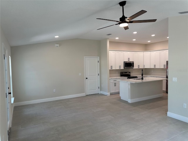 kitchen featuring a sink, appliances with stainless steel finishes, ceiling fan, light countertops, and baseboards