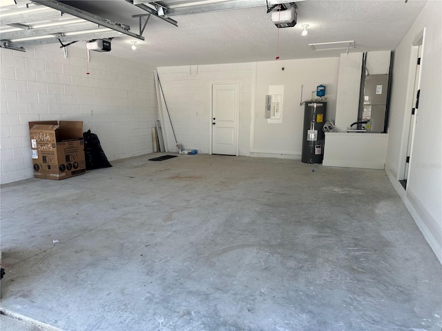 garage featuring concrete block wall, heating unit, a garage door opener, and electric water heater