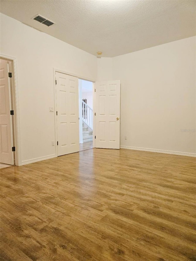 5421 Watervista Dr, Orlando, FL 32821 - unfurnished room with visible vents, baseboards, and wood finished floors