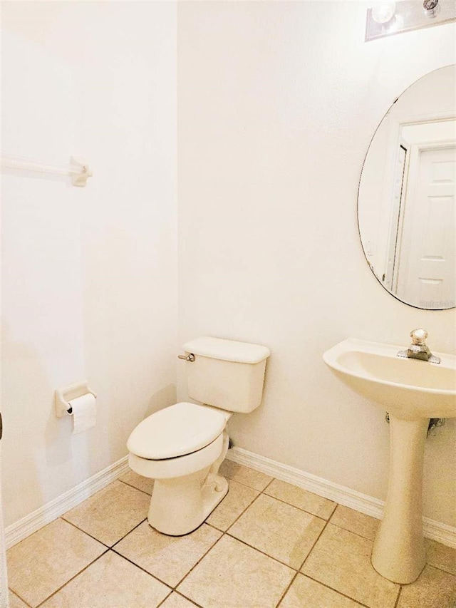 5421 Watervista Dr, Orlando, FL 32821 - half bath with tile patterned flooring, baseboards, and toilet