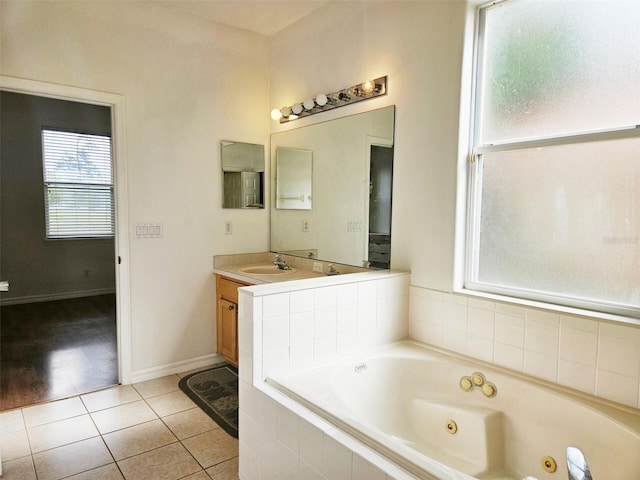5421 Watervista Dr, Orlando, FL 32821 - full bathroom with baseboards, a jetted tub, tile patterned flooring, and vanity