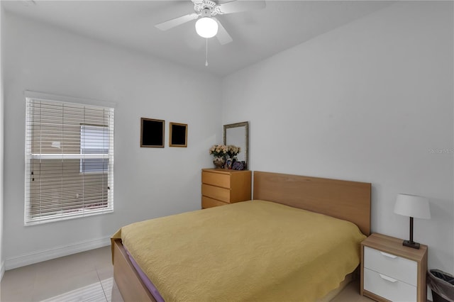 bedroom featuring ceiling fan, baseboards, and light tile patterned floors