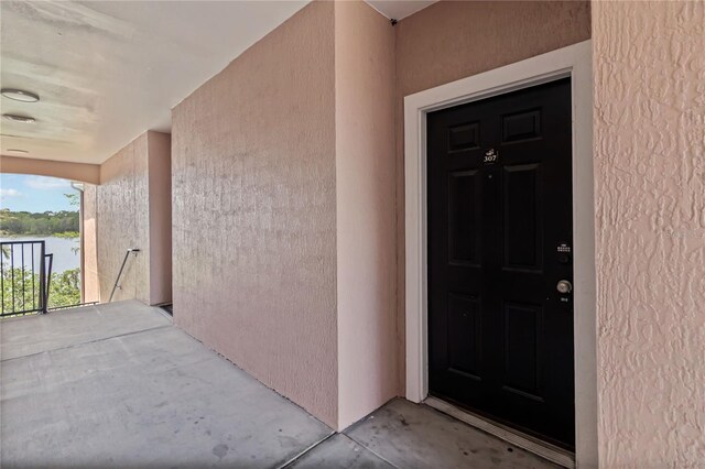 view of exterior entry with stucco siding