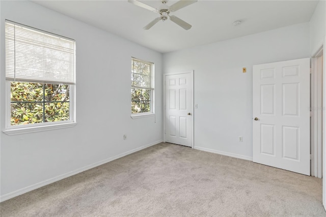 unfurnished bedroom with ceiling fan, carpet flooring, and baseboards