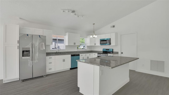 13838 Ginger Creek Blvd, Orlando, FL 32826 - kitchen with a sink, visible vents, appliances with stainless steel finishes, and white cabinetry