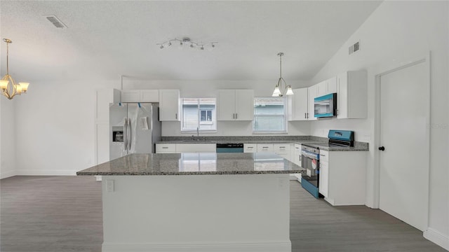 13838 Ginger Creek Blvd, Orlando, FL 32826 - kitchen featuring white cabinets, visible vents, appliances with stainless steel finishes, a sink, and a notable chandelier