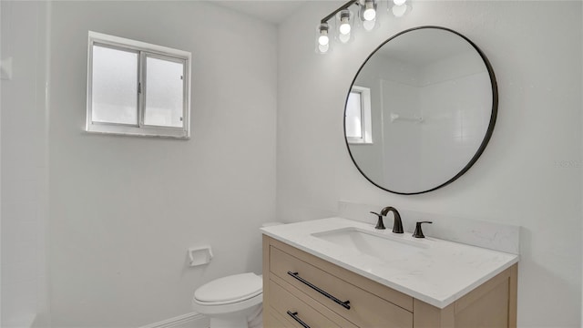 13838 Ginger Creek Blvd, Orlando, FL 32826 - bathroom with toilet, plenty of natural light, vanity, and baseboards