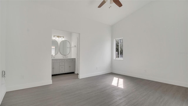 13838 Ginger Creek Blvd, Orlando, FL 32826 - unfurnished bedroom featuring high vaulted ceiling, ensuite bath, baseboards, and wood finished floors