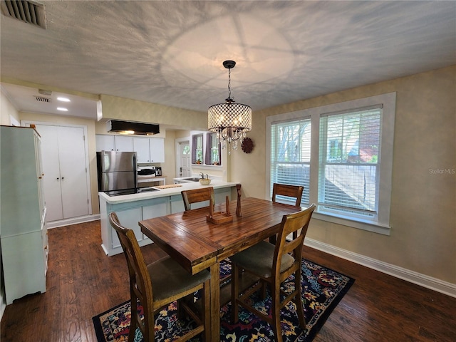 dining space with baseboards, dark wood-style floors, visible vents, and a notable chandelier