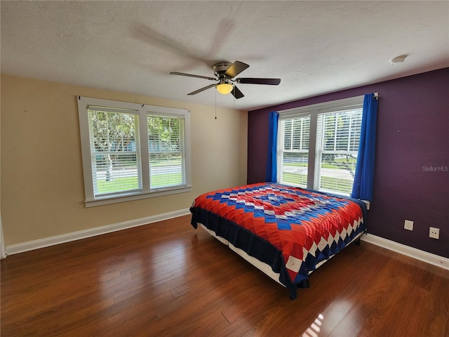 bedroom with baseboards, a ceiling fan, and wood finished floors