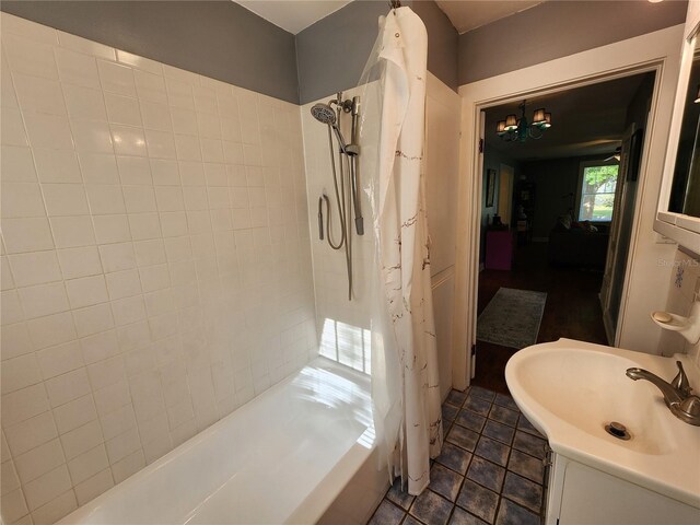 bathroom featuring vanity and shower / bath combination with curtain