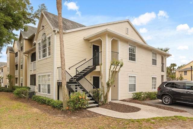 view of side of home featuring stairs