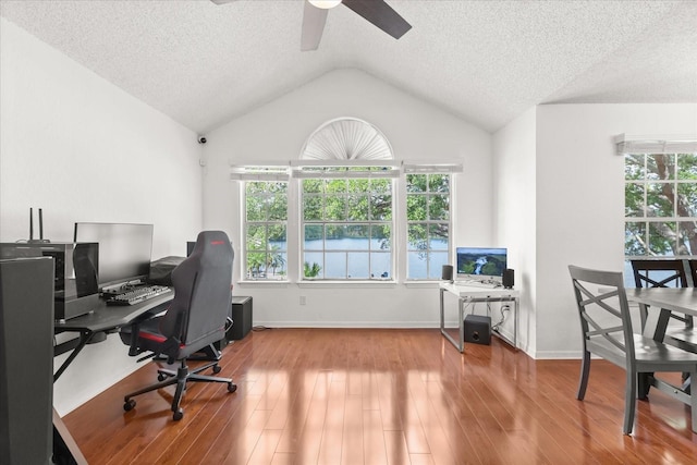 office space featuring a textured ceiling, wood finished floors, ceiling fan, and vaulted ceiling