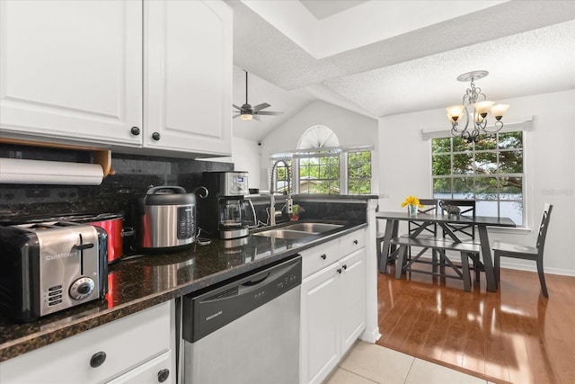 kitchen featuring a sink, white cabinets, dishwasher, and ceiling fan with notable chandelier