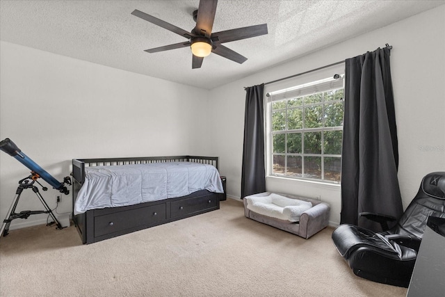 bedroom featuring a textured ceiling, baseboards, a ceiling fan, and carpet floors