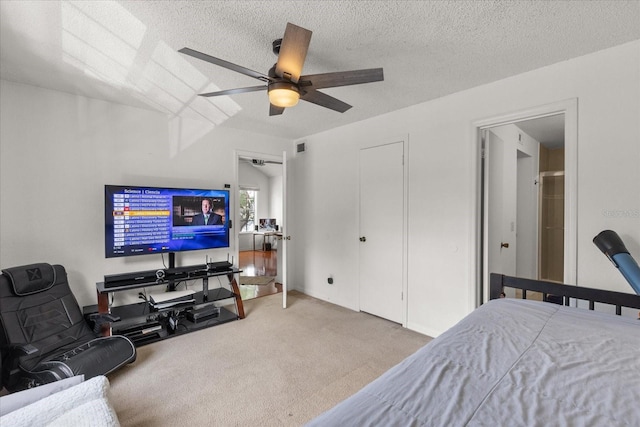 carpeted bedroom featuring visible vents, ceiling fan, and a textured ceiling