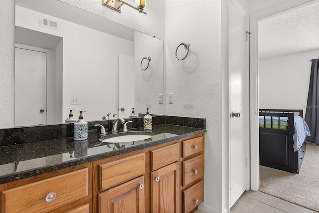 ensuite bathroom featuring visible vents, tile patterned floors, ensuite bathroom, and vanity