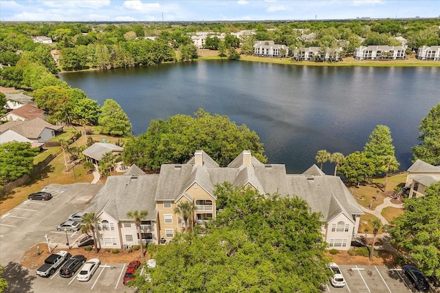 drone / aerial view featuring a water view and a residential view
