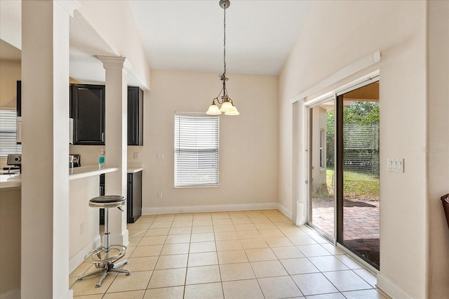 6959 Brescia Way, Orlando, FL 32819 - unfurnished dining area with baseboards, vaulted ceiling, and light tile patterned floors