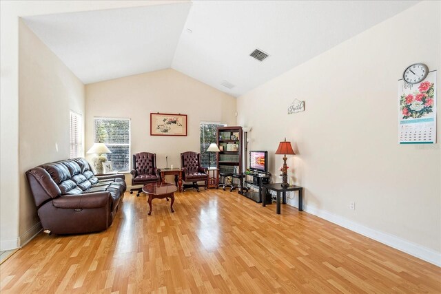 6959 Brescia Way, Orlando, FL 32819 - sitting room featuring light wood-style flooring, visible vents, lofted ceiling, and baseboards