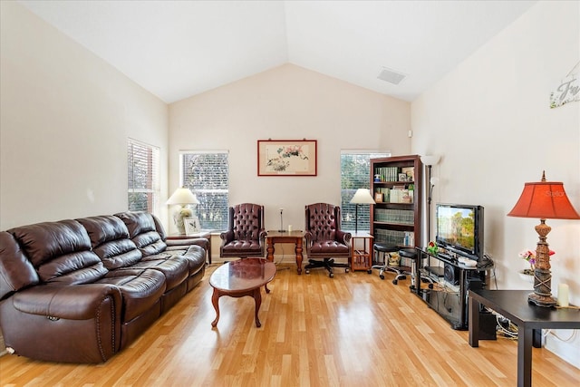6959 Brescia Way, Orlando, FL 32819 - living room featuring wood finished floors, visible vents, and a healthy amount of sunlight