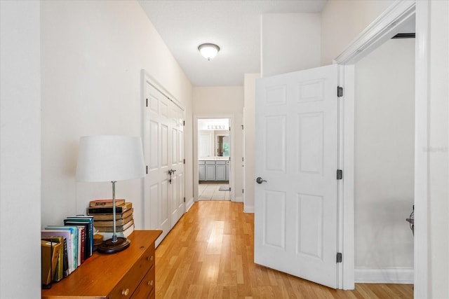 6959 Brescia Way, Orlando, FL 32819 - corridor with light wood-type flooring and baseboards