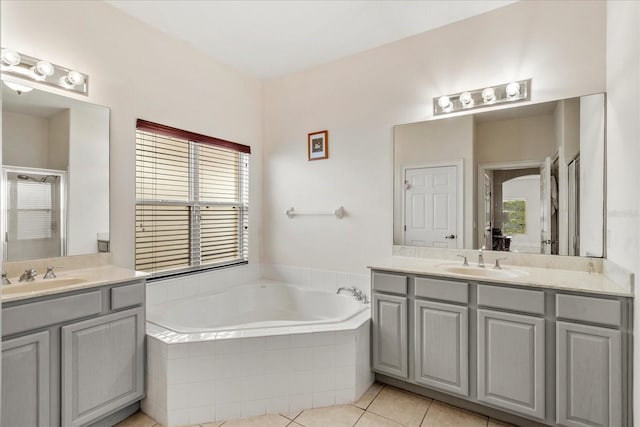6959 Brescia Way, Orlando, FL 32819 - full bathroom with two vanities, a bath, tile patterned flooring, and a sink