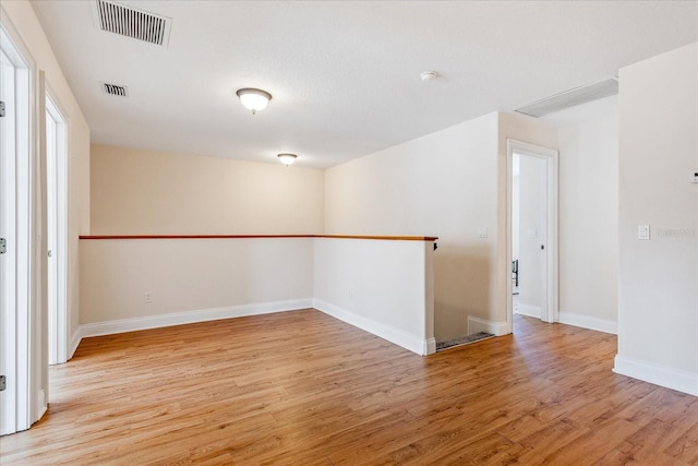 6959 Brescia Way, Orlando, FL 32819 - unfurnished room with baseboards, light wood-style floors, and visible vents