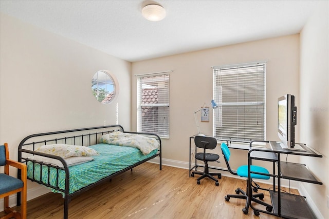 6959 Brescia Way, Orlando, FL 32819 - bedroom featuring wood finished floors and baseboards