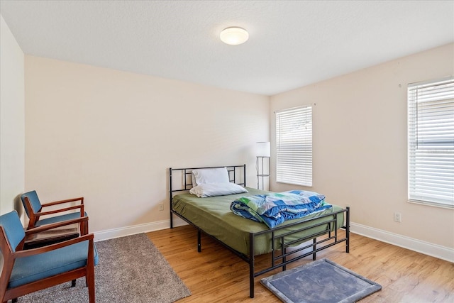 6959 Brescia Way, Orlando, FL 32819 - bedroom featuring light wood-style flooring and baseboards