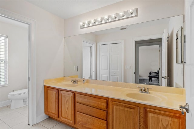 6959 Brescia Way, Orlando, FL 32819 - full bathroom featuring double vanity, a wealth of natural light, tile patterned floors, and a sink