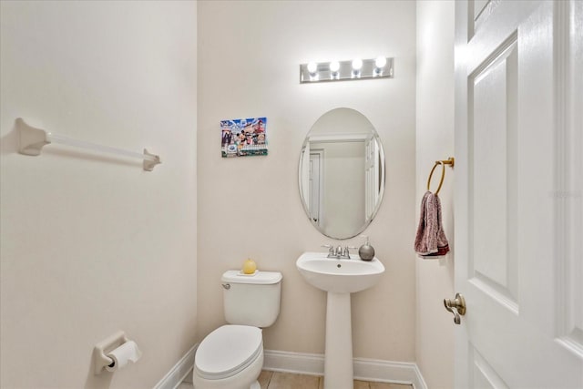 6959 Brescia Way, Orlando, FL 32819 - bathroom featuring toilet, tile patterned flooring, and baseboards