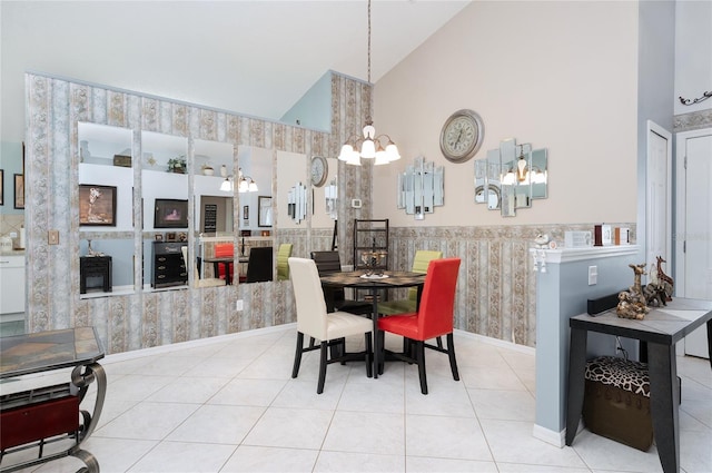 dining room featuring tile patterned floors, high vaulted ceiling, a chandelier, and wallpapered walls