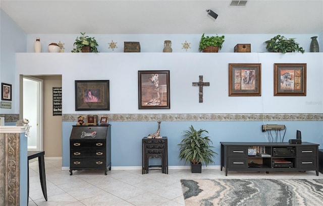 tiled living room with baseboards and visible vents