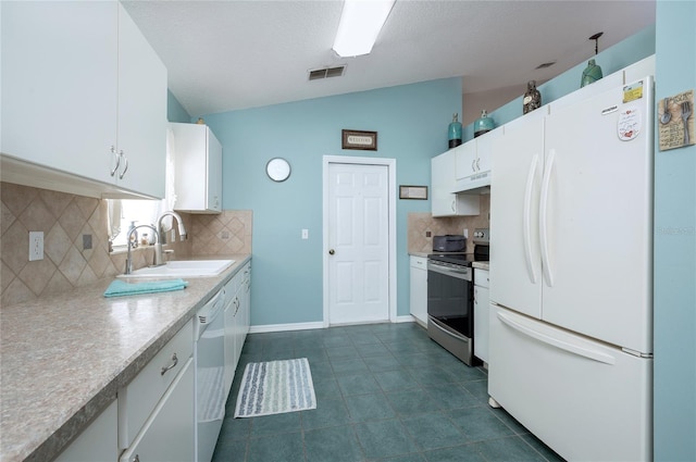 kitchen featuring tasteful backsplash, white cabinets, a sink, white appliances, and lofted ceiling