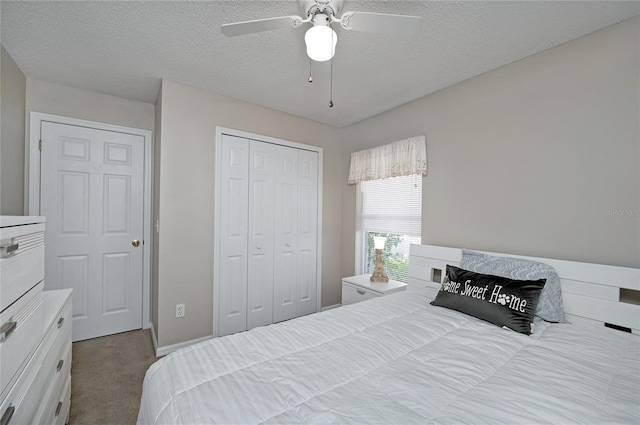 carpeted bedroom with a closet, a textured ceiling, and ceiling fan