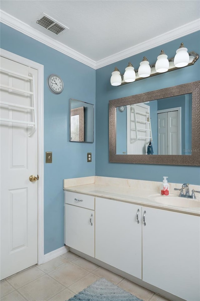 bathroom with crown molding, vanity, baseboards, tile patterned flooring, and visible vents