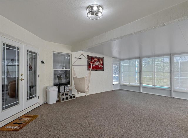 interior space featuring french doors and a textured ceiling