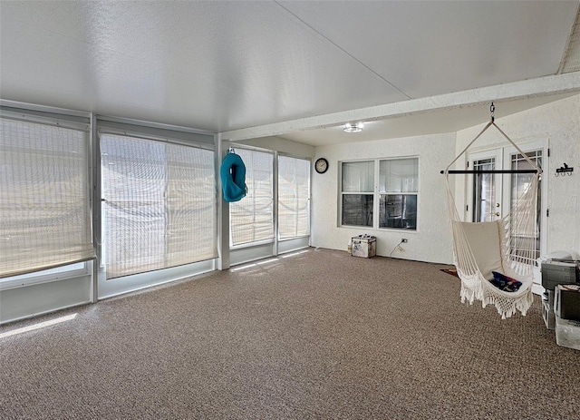 unfurnished sunroom with carpet
