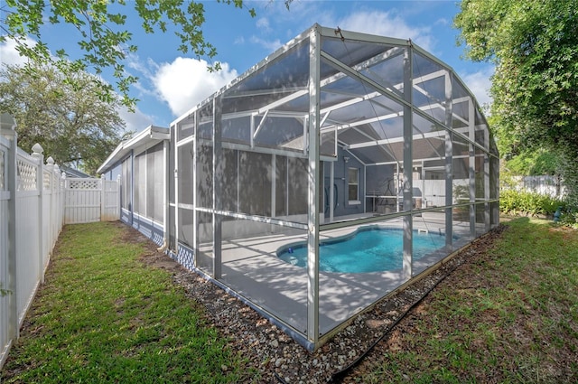 view of pool with a patio area, a fenced backyard, a yard, a fenced in pool, and a lanai