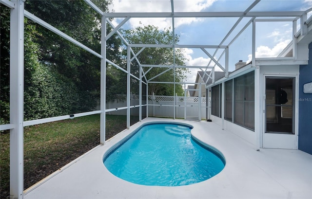 view of pool with a fenced backyard, a fenced in pool, a patio area, and glass enclosure
