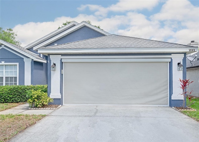 ranch-style house with stucco siding and driveway